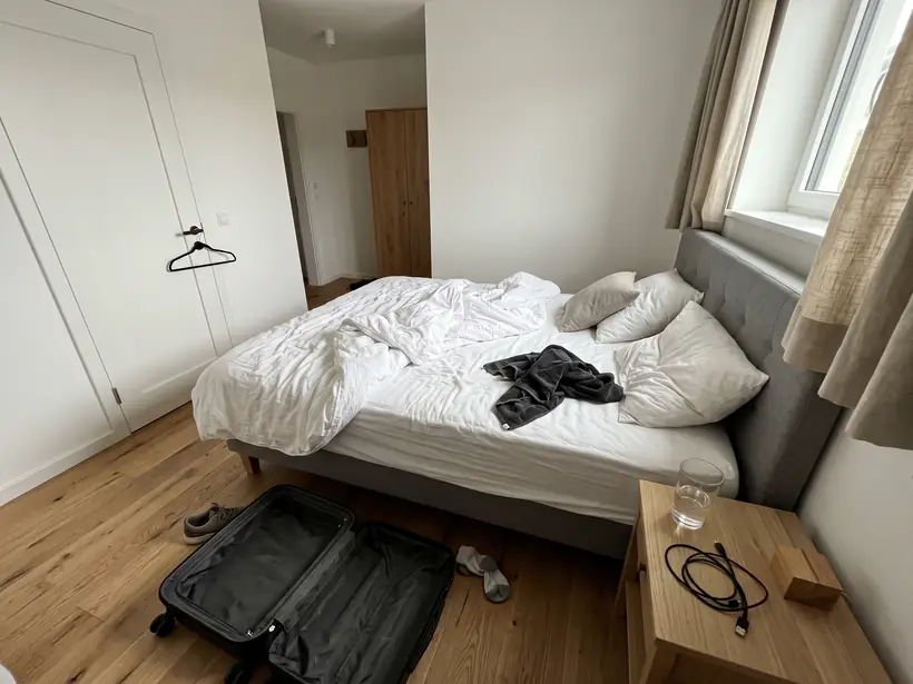 Schlafzimmer einer Ferienwohnung mit unordentlichem Bett nach der Abreise
